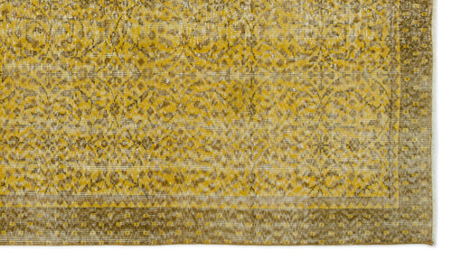 Load image 1 in gallery view. Mustard yellow and brown distressed rug with a traditional floral medallion pattern and a geometric border.