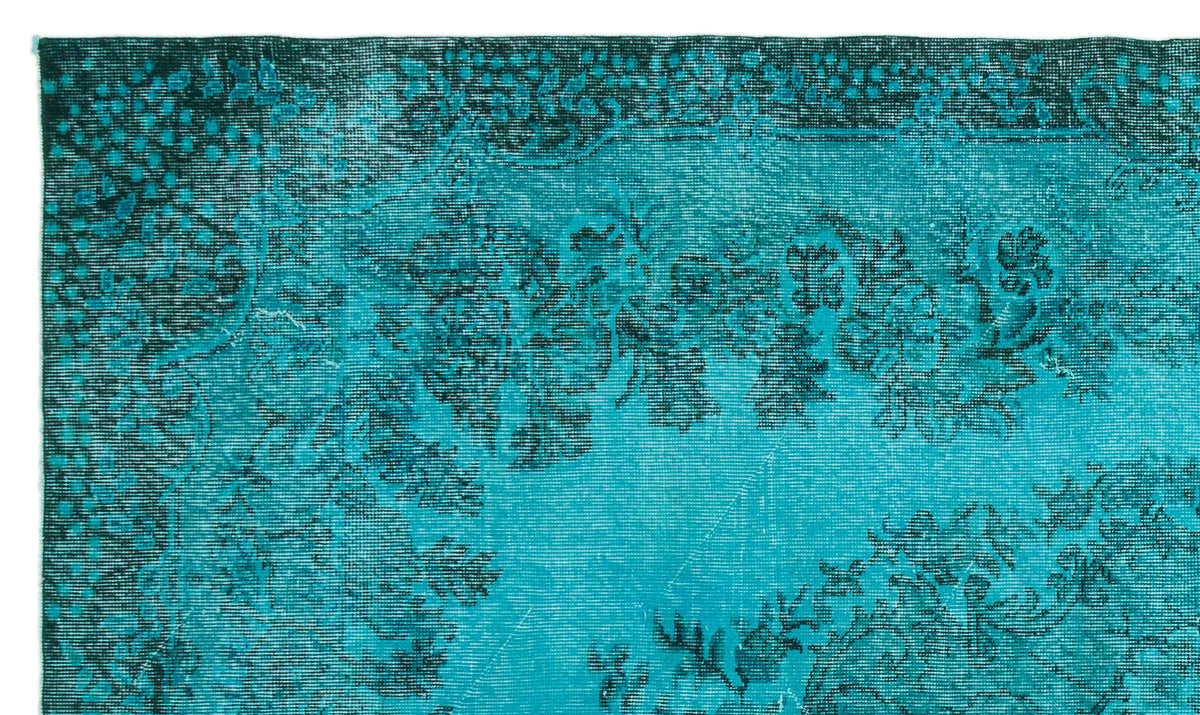 Teal and black distressed rug with a traditional floral medallion pattern and ornate border.