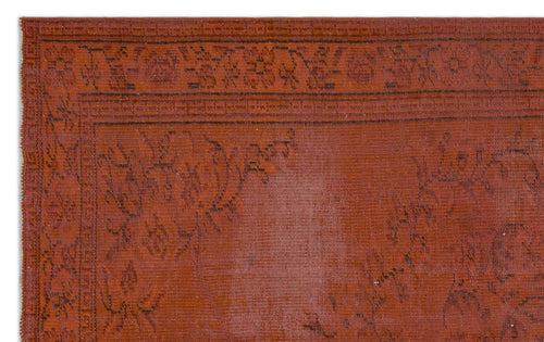 Load image 1 in gallery view. Rust-colored rug with a dark brown floral border and faint, distressed botanical motifs.