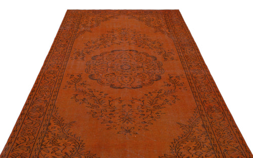Load image 1 in gallery view. Burnt orange vintage-style rug with a dark brown central floral medallion and ornate border pattern.
