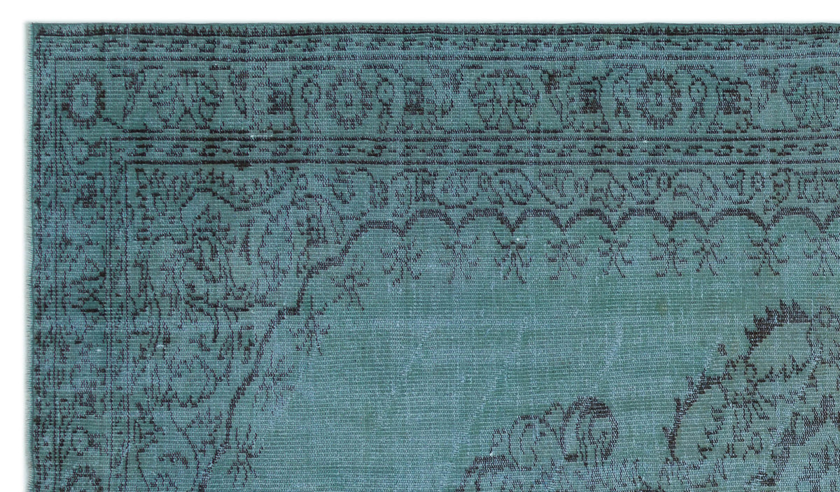 Teal and dark grey rug with a distressed traditional floral medallion border and intricate vine patterns.