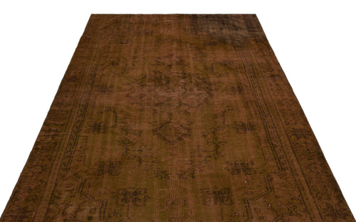 Load image 1 in gallery view. Dark brown vintage-style rug with a faint, distressed traditional medallion pattern on a white background.