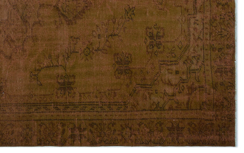 Load image 1 in gallery view. Monochromatic brown rug with a faded, traditional floral medallion pattern and a detailed border.