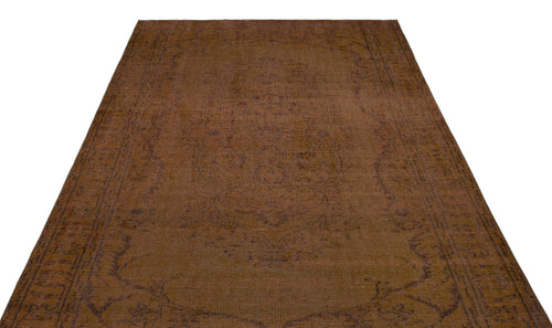 Load image 1 in gallery view. Dark brown vintage-style rug with a faint, tonal medallion pattern and a decorative border.