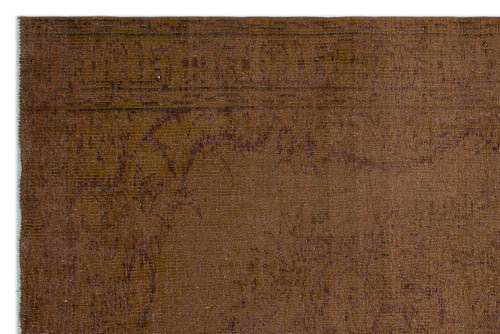 Load image 1 in gallery view. Solid brown rug with a subtle, distressed tonal pattern and a linear border detail.