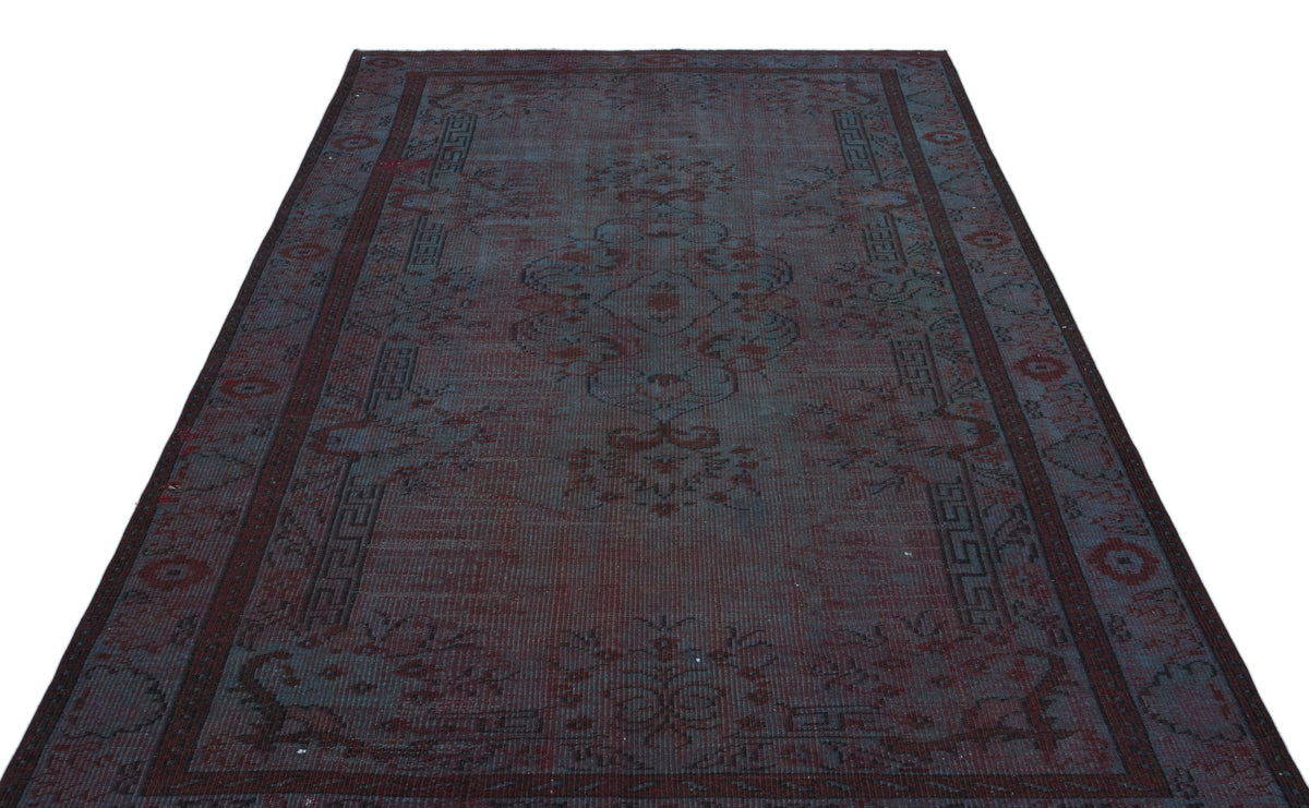 Dark charcoal and deep red distressed traditional rug with a central medallion and geometric border pattern.
