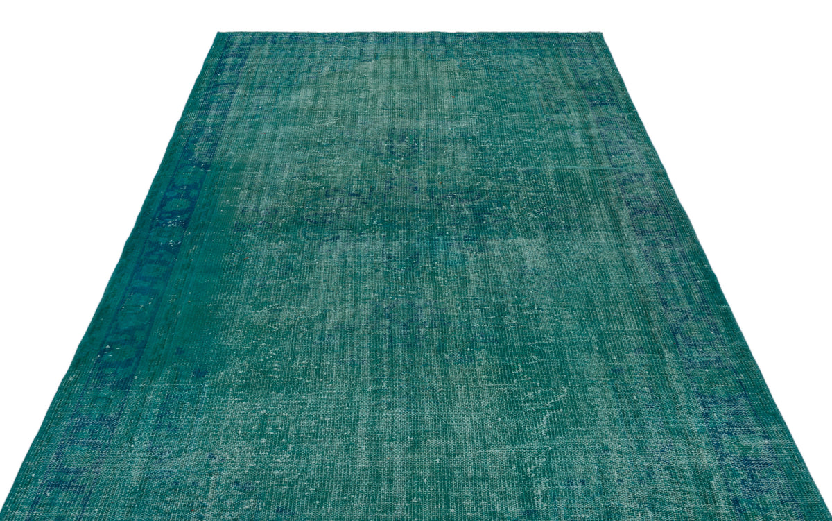 Teal and blue distressed vintage-style rug with a faded traditional pattern on a white background.