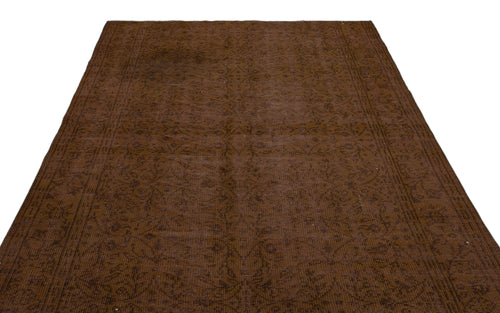 Load image 1 in gallery view. Dark brown monochromatic rug with a subtle, distressed floral medallion pattern and a bordered edge.