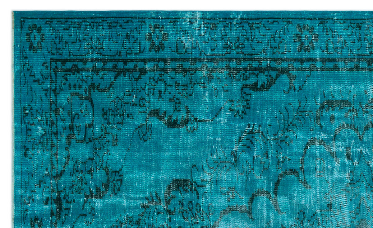 Teal rug with a distressed black traditional floral border and medallion pattern.