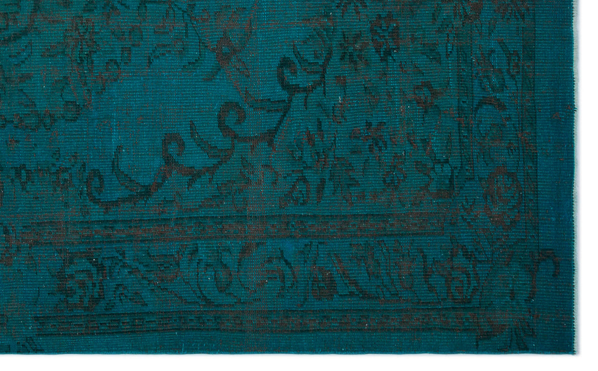 Teal rug with a dark charcoal traditional floral medallion pattern and a detailed border.