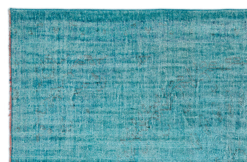 Load image 1 in gallery view. Teal and turquoise distressed rug with a faded, textured pattern and a frayed edge.