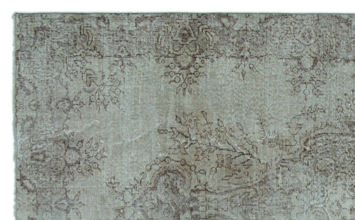 Load image 1 in gallery view. Taupe and brown vintage-style rug with a faded, distressed floral medallion pattern.