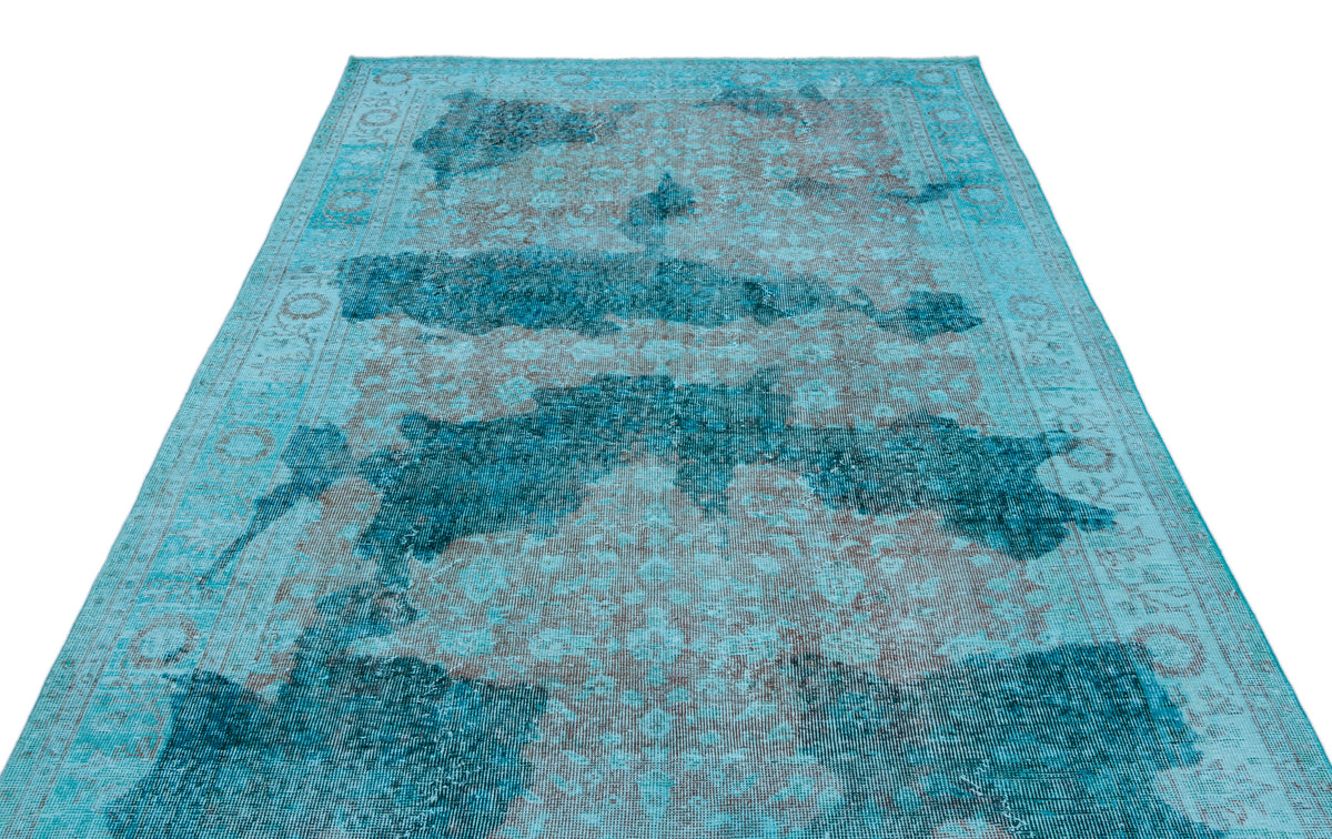 Turquoise and grey distressed area rug with a faded traditional medallion pattern and a decorative border.