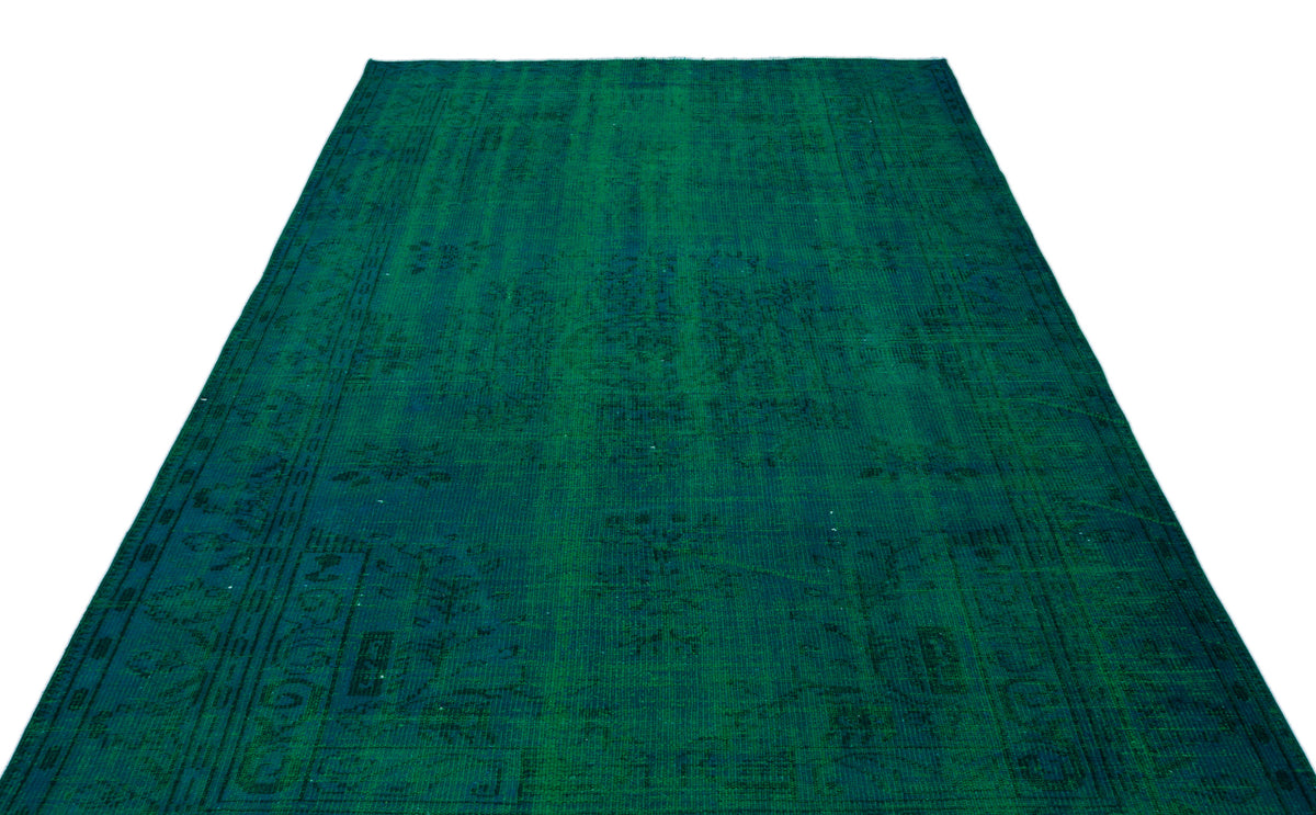 Emerald green vintage-style rug with a faint, distressed traditional medallion pattern on a white background.