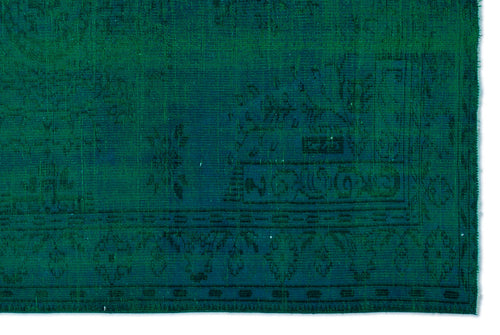 Load image 1 in gallery view. Emerald green vintage-style rug with a faded, dark teal traditional medallion and border pattern.
