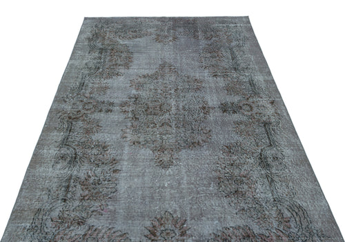 Load image 1 in gallery view. Grey and brown distressed vintage-style rug with a central floral medallion and ornate border on a white background.