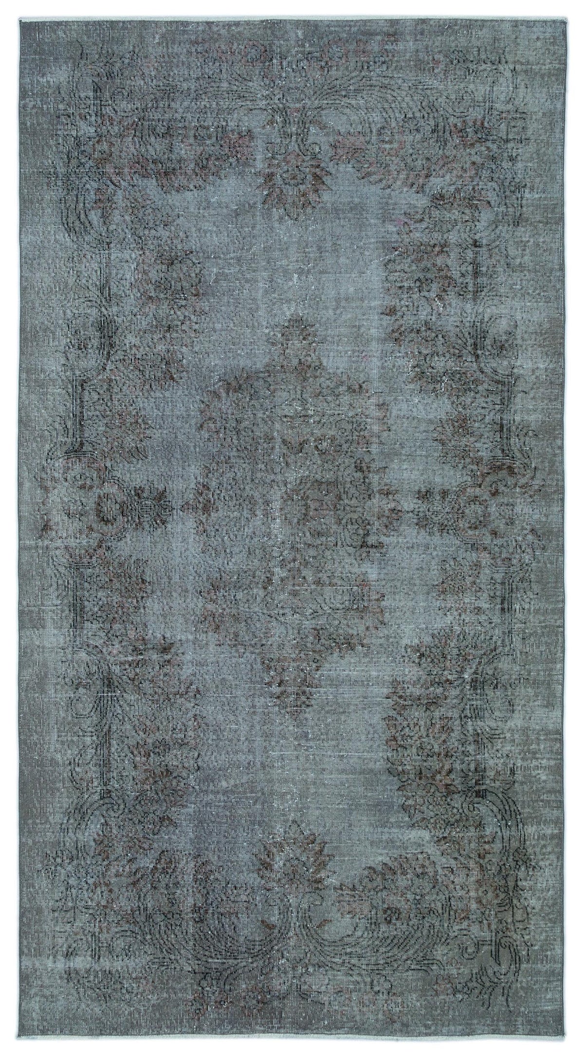 Distressed slate blue rug with a faded central floral medallion and ornate border in muted charcoal and rust tones.