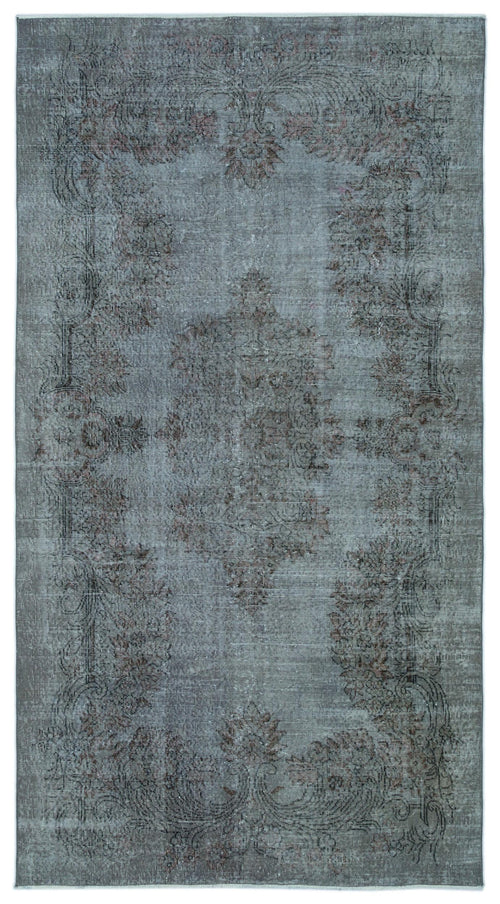 Load image 1 in gallery view. Distressed slate blue rug with a faded central floral medallion and ornate border in muted charcoal and rust tones.