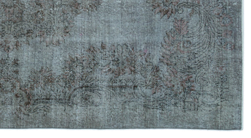 Load image 1 in gallery view. Distressed slate blue rug with a faded floral medallion pattern in muted brown and charcoal tones.