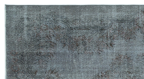 Load image 1 in gallery view. Distressed charcoal and grey rug with a faded floral medallion pattern.