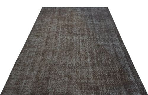 Load image 1 in gallery view. Dark brown distressed vintage-style rug with a faded, textured monochromatic pattern on a white background.