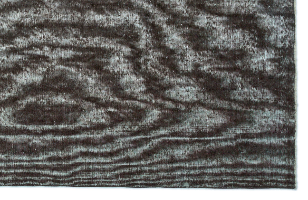 Dark brown distressed rug with a fine horizontal linear texture and subtle worn-in detailing.