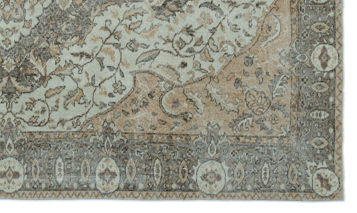 Distressed beige, brown, and cream rug with a traditional floral medallion pattern and a detailed border.