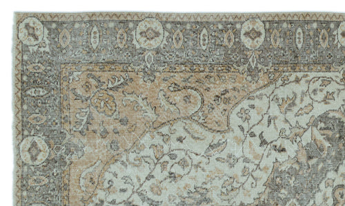 Load image 1 in gallery view. Distressed beige, cream, and charcoal traditional rug with a floral medallion border and intricate botanical motifs.