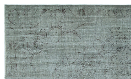 Load image 1 in gallery view. Sage green rug with a distressed, faded traditional floral medallion pattern in dark grey.