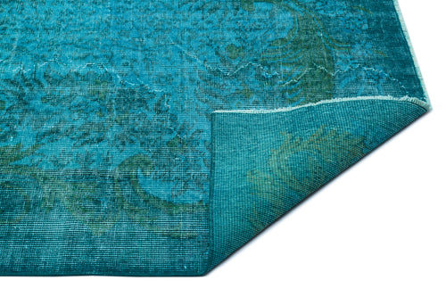 Load image 1 in gallery view. Teal and dark green distressed medallion rug with a folded corner, isolated on a white background.