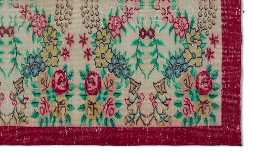 Load image 1 in gallery view. Beige rug with a floral pattern in red, yellow, and blue, featuring a wide red border.