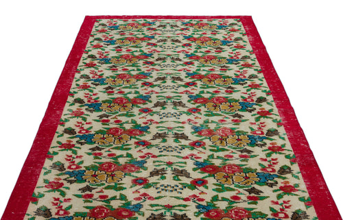 Load image 1 in gallery view. Cream runner rug with a red border and a repeating floral pattern in red, yellow, blue, and green.