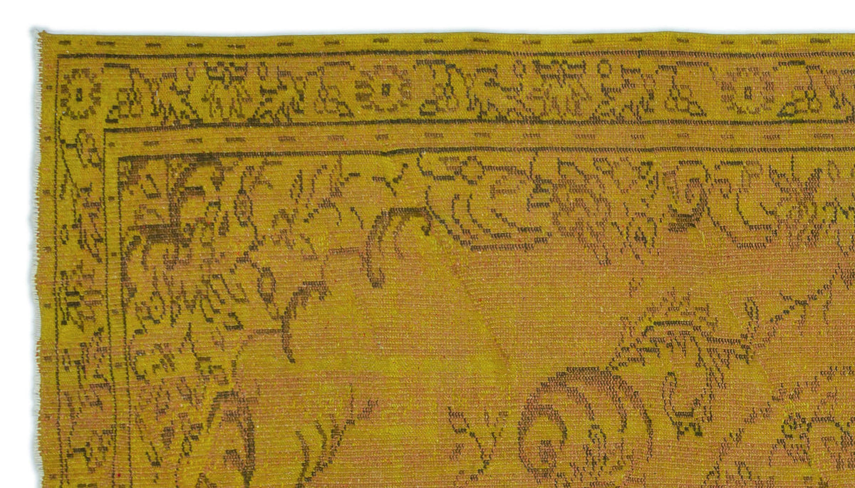 Mustard yellow rug with a dark brown distressed floral border and central vine pattern.