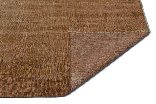 Load image 1 in gallery view. Solid rust-brown distressed rug with a folded corner revealing the textured underside on a white background.