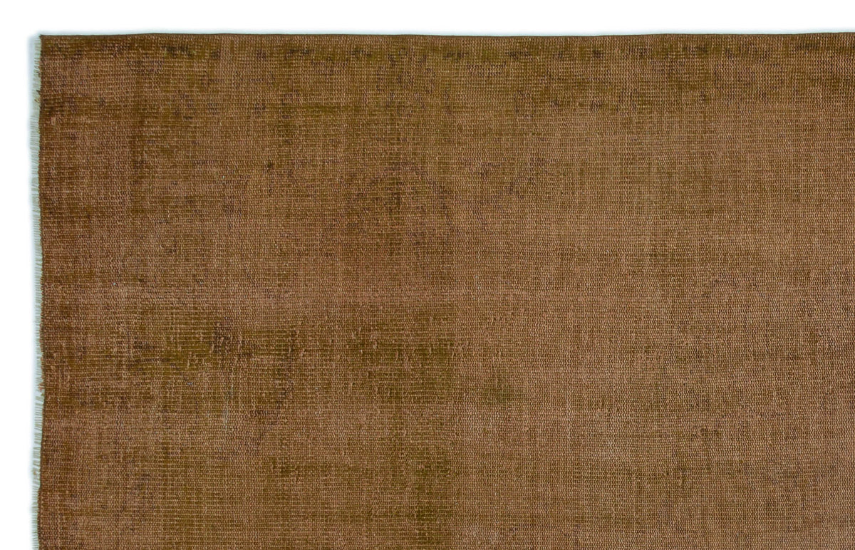 Solid brown rug with a distressed, weathered texture and visible woven fiber detail.