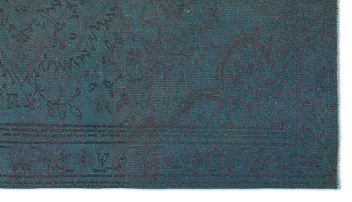 Load image 1 in gallery view. Teal and dark blue distressed rug with a faint, traditional medallion pattern and speckled red accents.