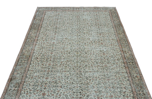 Load image 1 in gallery view. Distressed beige and muted pink rug with an all-over floral vine pattern and a decorative border.