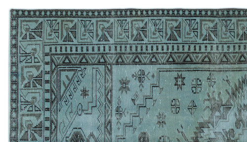 Load image 1 in gallery view. Teal and charcoal rug with a distressed geometric border and scattered tribal motifs.
