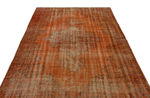 Load image 1 in gallery view. Distressed burnt orange vintage-style rug with a faded central medallion and intricate border pattern on white background.