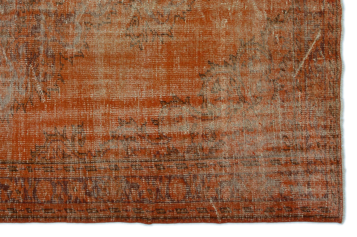 Burnt orange and cream vintage-style rug with a distressed, faded traditional medallion pattern.