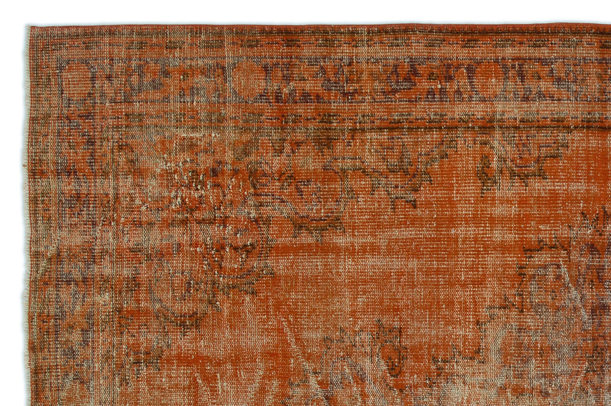 Burnt orange vintage-style rug with a distressed, faded traditional medallion pattern and a bordered edge.
