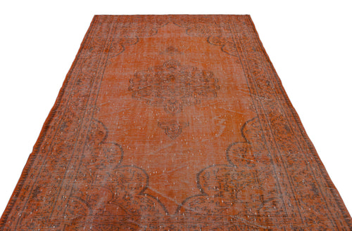 Load image 1 in gallery view. Distressed burnt orange rug with a faded charcoal grey central medallion and ornate border on a white background.