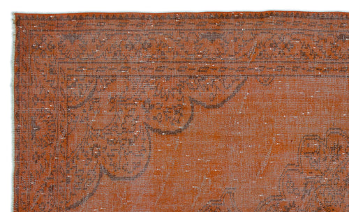 Load image 1 in gallery view. Burnt orange vintage-style rug with a distressed dark brown floral medallion border and white flecked texture.