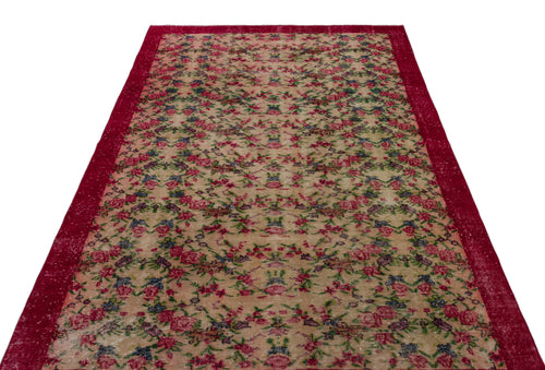 Load image 1 in gallery view. Beige rug with a distressed floral pattern and a wide, solid red border on a white background.