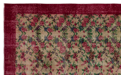 Load image 1 in gallery view. Beige rug with a distressed floral pattern in red, green, and blue, featuring a solid deep red border.