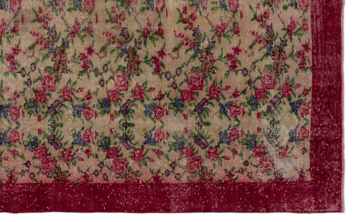 Load image 1 in gallery view. Beige rug with a distressed floral pattern in red, blue, and green, featuring a solid deep red border.