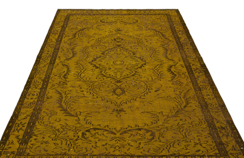 Load image 1 in gallery view. Mustard yellow and brown vintage-style rug with a central floral medallion and ornate border on a white background.