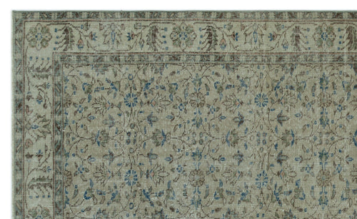 Load image 1 in gallery view. Beige traditional rug with a distressed floral medallion pattern in muted blue, brown, and sage green.