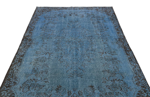 Load image 1 in gallery view. Blue and charcoal distressed traditional rug with a central floral medallion and ornate border on a white background.