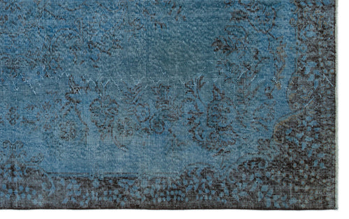 Load image 1 in gallery view. Blue and dark brown distressed rug with a faded floral medallion pattern.